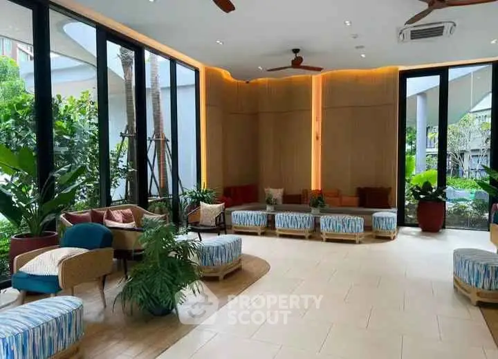 Stylish modern lobby with cozy seating and lush greenery views.