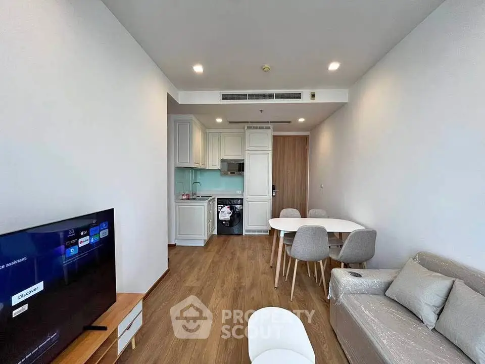 Modern living room with open kitchen and stylish furniture in a contemporary apartment.