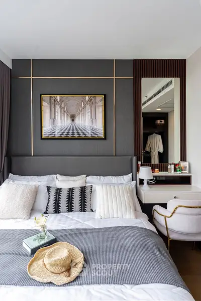 Luxurious bedroom with elegant decor and stylish furnishings, featuring a cozy bed and chic wall art.