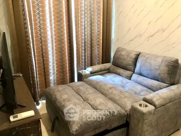 Cozy living room with plush gray recliner and modern decor