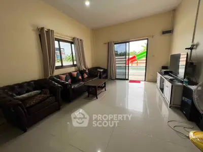 Spacious living room with modern furniture and large windows for natural light