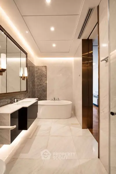 Luxurious modern bathroom with elegant marble finishes and a stylish bathtub.
