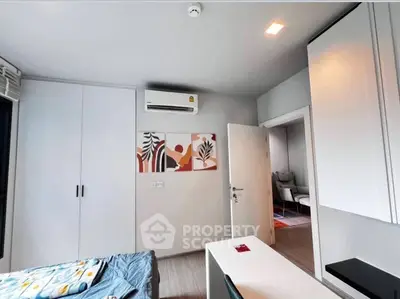 Modern bedroom with stylish decor and ample storage in a contemporary apartment.