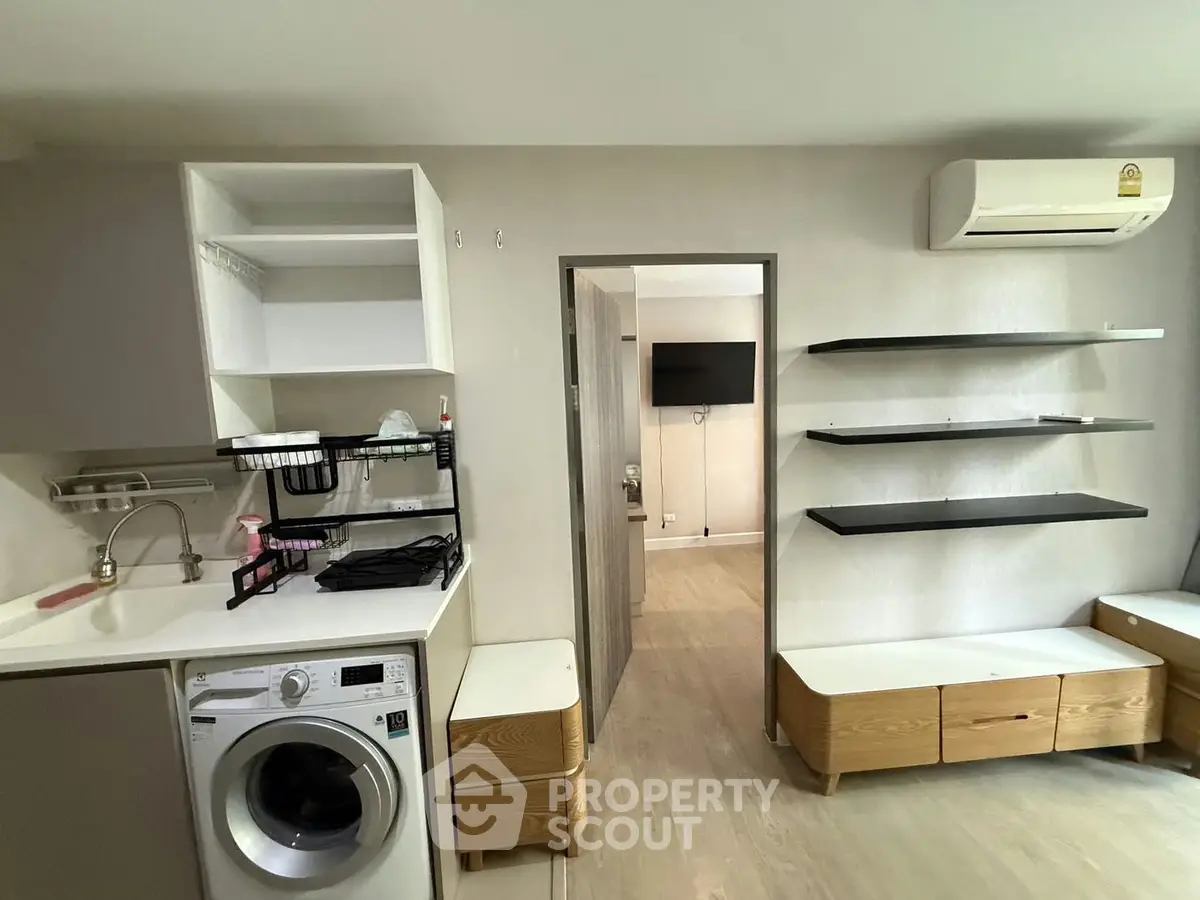 Modern apartment interior with washing machine and sleek shelving