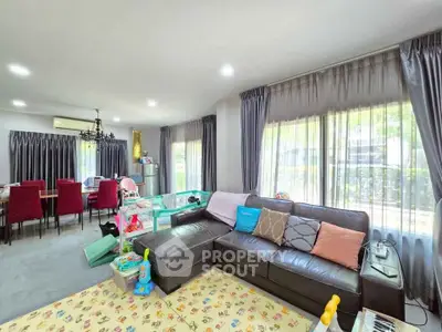 Spacious living room with modern decor and large windows in a family-friendly home.