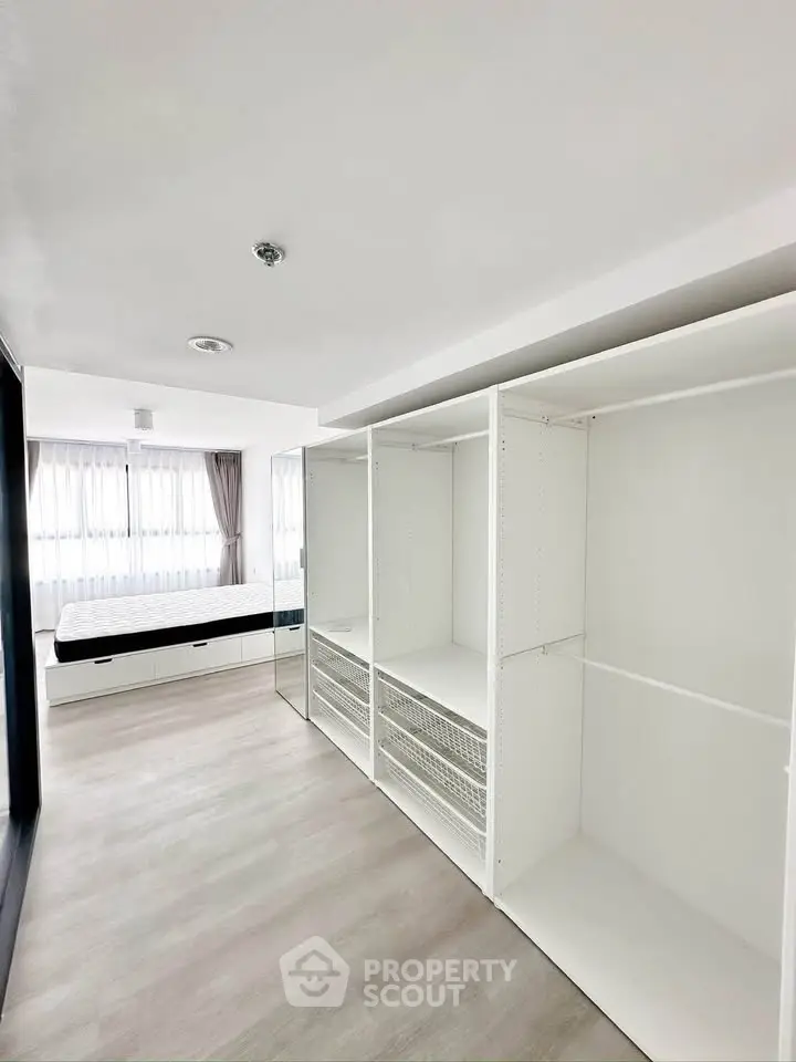 Spacious bedroom with built-in wardrobes and large windows for natural light.