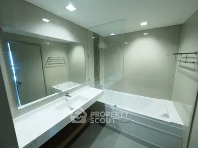 Modern bathroom with sleek design and bathtub in contemporary apartment.