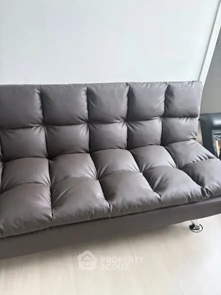 Modern brown leather sofa in a stylish living room setting.
