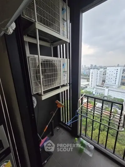 High-rise balcony with air conditioning units and city view, ideal for urban living.