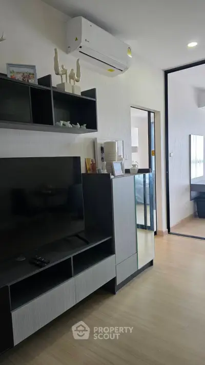 Modern living room with sleek furniture and air conditioning unit