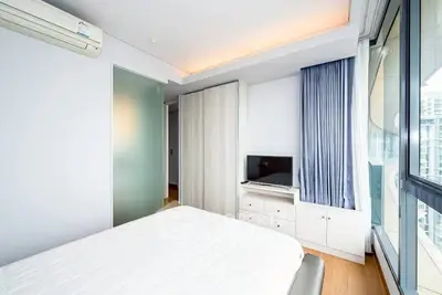Modern bedroom with sleek design and natural light in urban apartment