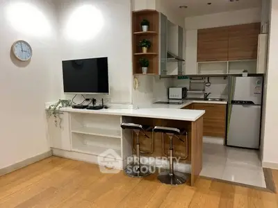 Modern open-layout kitchen with breakfast bar and sleek appliances