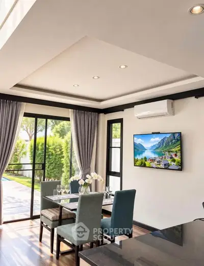 Modern dining area with garden view, featuring elegant decor and natural light.