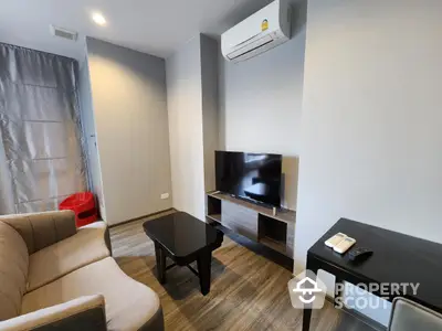 Modern living room with air conditioning and flat-screen TV in stylish apartment.