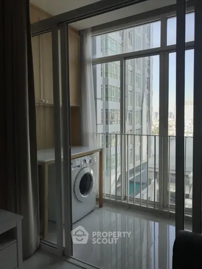 Modern apartment balcony with washing machine and city view