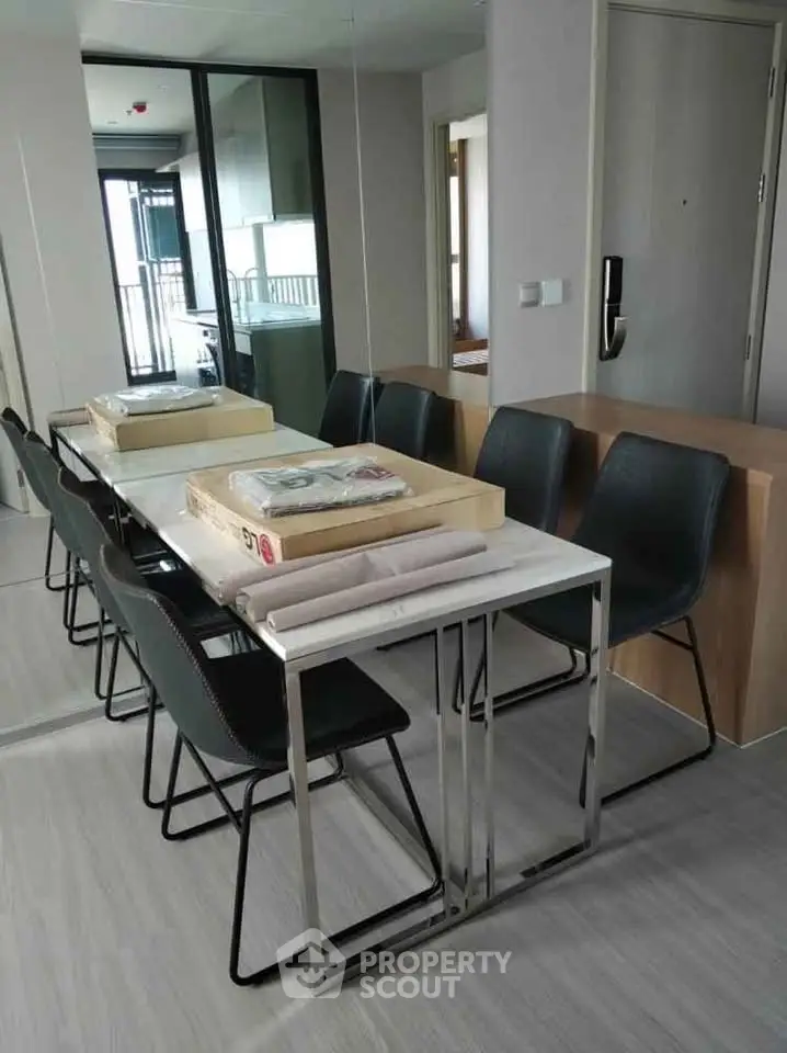 Modern dining area with sleek table and chairs in a stylish apartment interior.