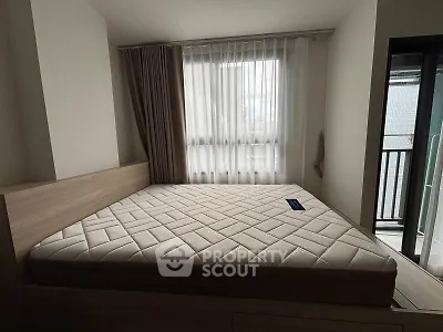 Spacious bedroom with large window and modern decor