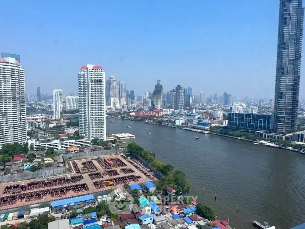 Stunning river view from high-rise apartment in bustling city skyline.