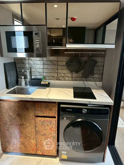 Modern compact kitchen with sleek appliances and stylish design