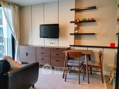 Modern living room with stylish furniture and wall-mounted TV in a cozy apartment.