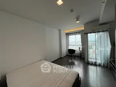 Spacious bedroom with city view and modern furnishings