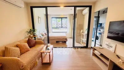 Modern studio apartment with open layout, cozy living area, and stylish bedroom.