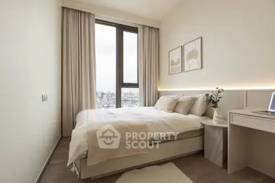 Modern bedroom with city view, featuring elegant decor and natural light.