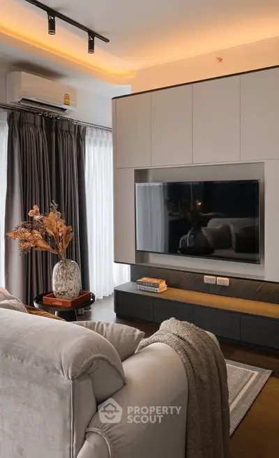 Modern living room with sleek TV setup and cozy decor