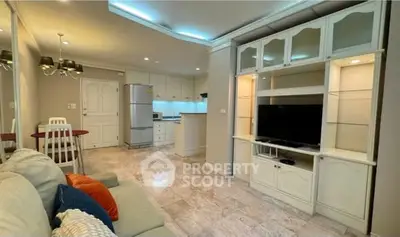 Charming open-layout living room with modern kitchen and cozy seating area, perfect for entertaining.