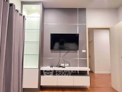 Modern living room with wall-mounted TV and sleek storage unit