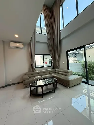 Spacious modern living room with high ceilings and large windows