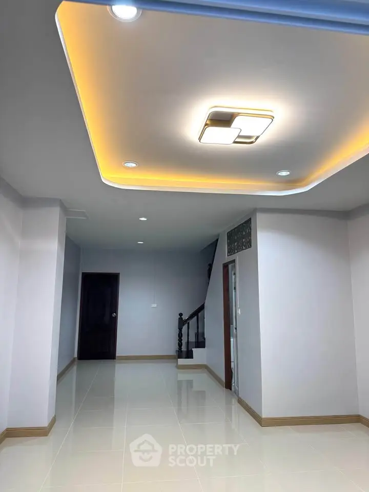 Spacious modern interior with elegant ceiling lighting and glossy tiled floors