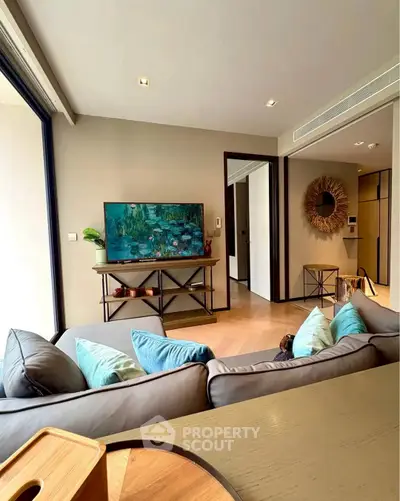 Modern living room with stylish decor and large windows for natural light.
