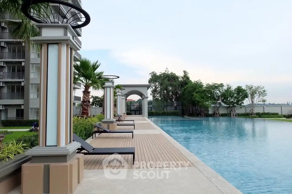 Luxurious apartment complex with a stunning outdoor pool and lush greenery, perfect for relaxation and leisure.