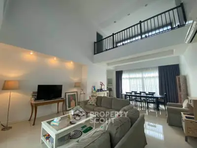 Spacious modern living room with high ceiling and elegant decor