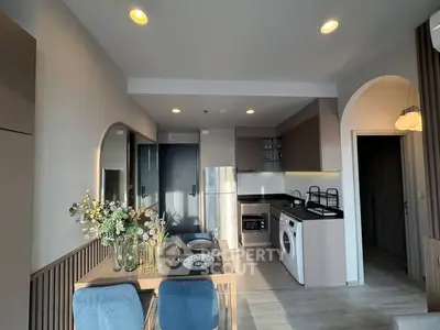 Modern kitchen and dining area with stylish decor and integrated appliances