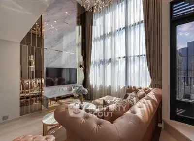 Luxurious living room with high ceilings, elegant chandelier, and panoramic city view.