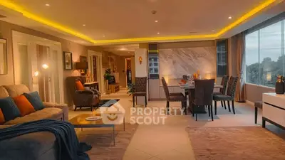 Luxurious open-plan living and dining area with modern decor and large windows.