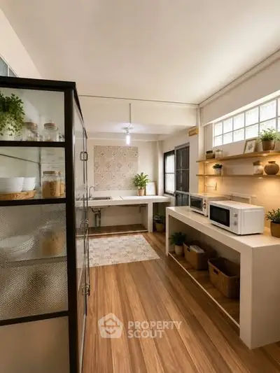 Charming kitchen with wooden flooring and modern appliances, featuring open shelving and natural light.
