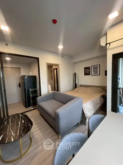 Modern studio apartment with cozy living area and stylish decor