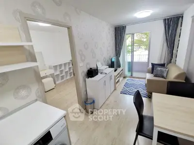 Modern living room with open layout and balcony access, featuring stylish furniture and natural light.