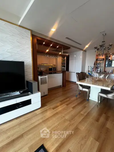 Spacious open-plan living and dining area with modern kitchen and elegant decor.