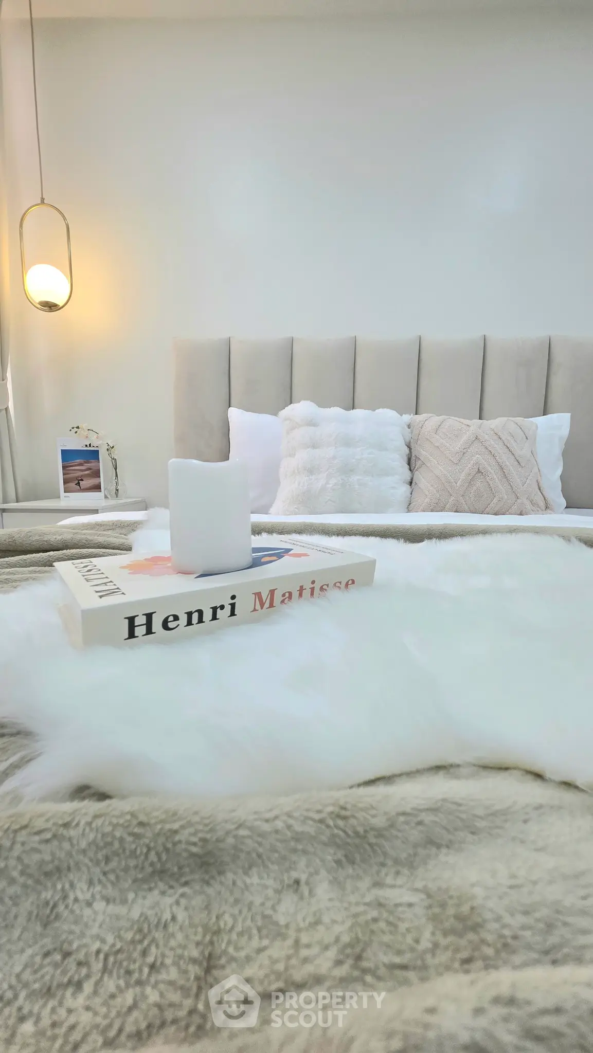 Luxurious bedroom with plush bedding and elegant lighting, perfect for relaxation.