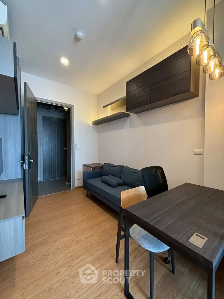 Modern living room with stylish lighting and cozy seating in a contemporary apartment.