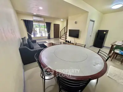 Spacious living room with modern furniture and dining area in open layout