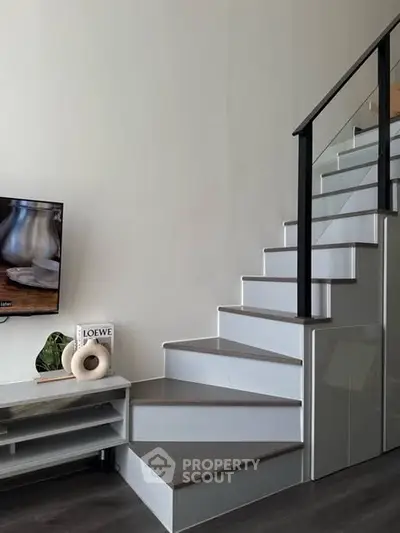 Modern staircase with sleek design and stylish decor in a contemporary home interior.