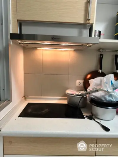 Modern kitchen with electric stove and sleek range hood