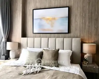 Luxurious bedroom with elegant decor and soft lighting, featuring a plush bed and stylish artwork.