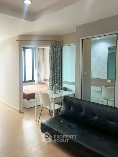 Modern apartment interior with cozy living room and bedroom, featuring stylish furniture and natural light.