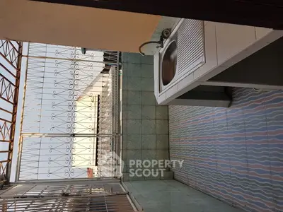 Charming balcony with tiled floor and outdoor sink, perfect for relaxation.